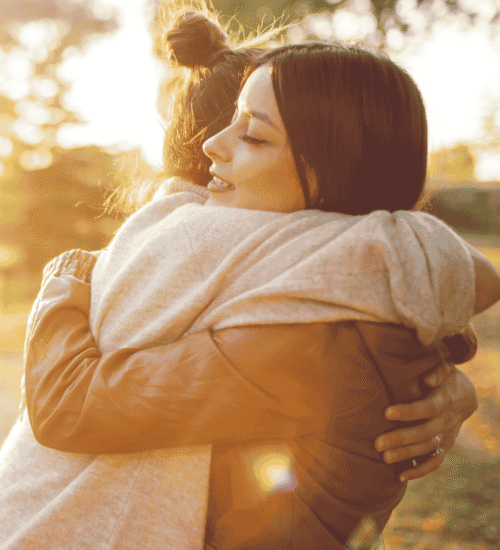 individuals hugging,